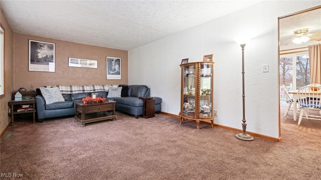 living room with carpet flooring, ceiling fan, and a textured ceiling