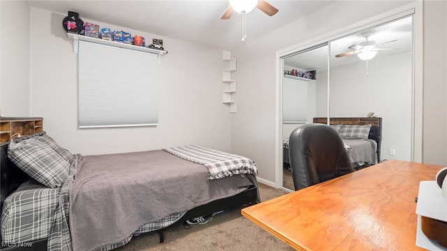 carpeted bedroom featuring ceiling fan and a closet