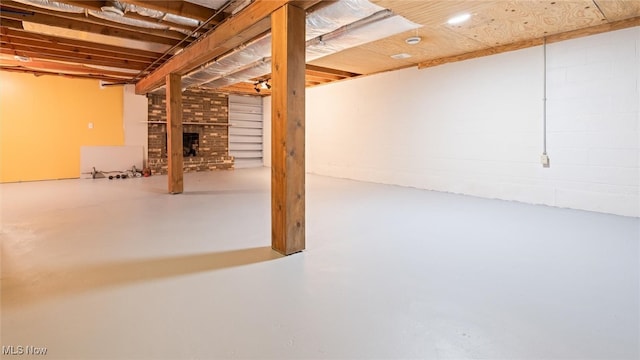 basement featuring a brick fireplace