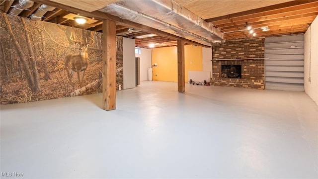 basement featuring a brick fireplace