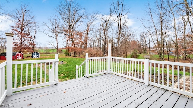 deck with a yard and a shed