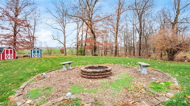 view of yard featuring a shed and an outdoor fire pit