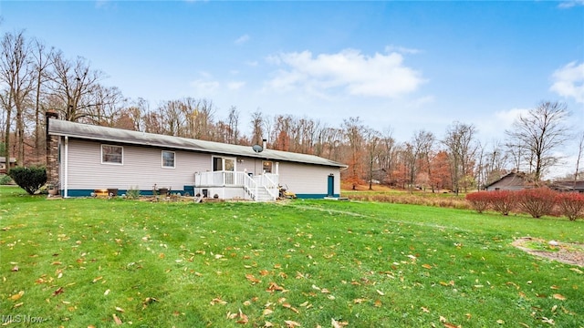 rear view of house featuring a yard