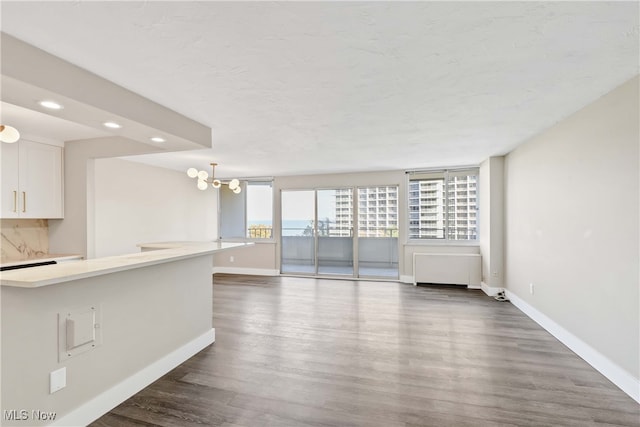 interior space with dark hardwood / wood-style floors and an inviting chandelier