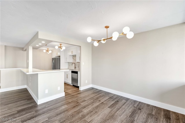 interior space featuring dark hardwood / wood-style floors, sink, and a chandelier