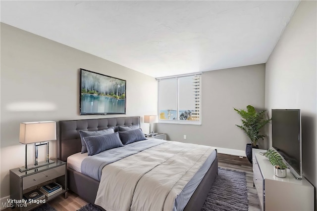 bedroom featuring dark hardwood / wood-style flooring