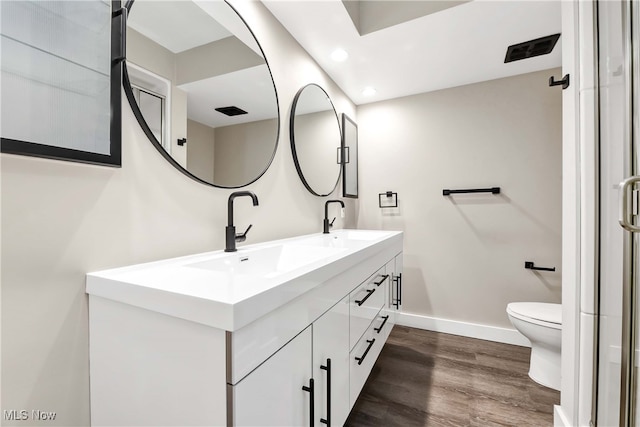 bathroom featuring hardwood / wood-style floors, vanity, and toilet