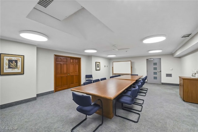 carpeted dining room featuring ceiling fan