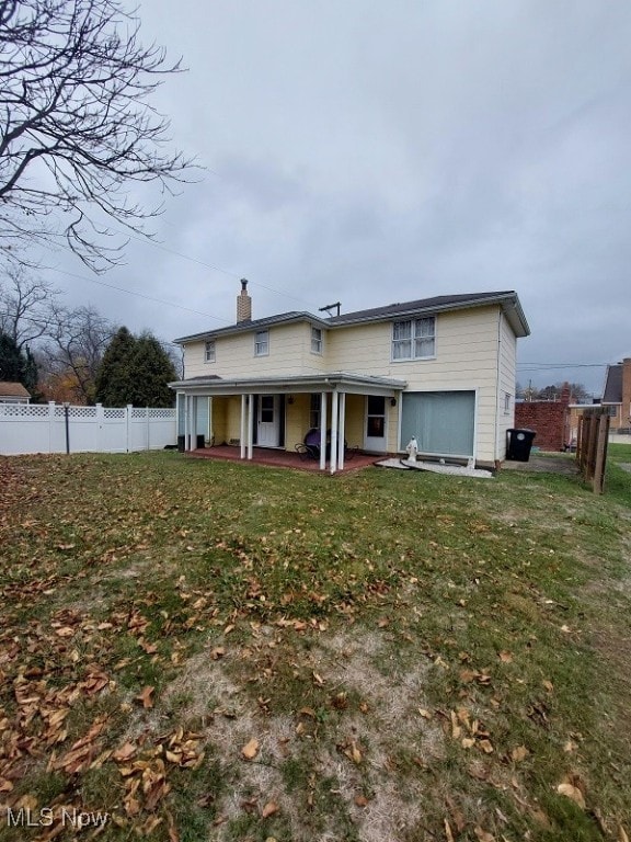 back of house featuring a yard and a patio