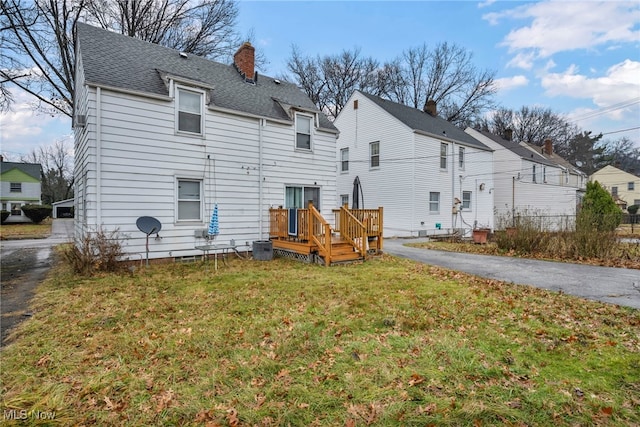 back of house with a yard and a deck