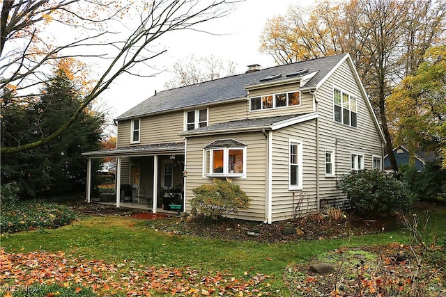 rear view of house with a yard