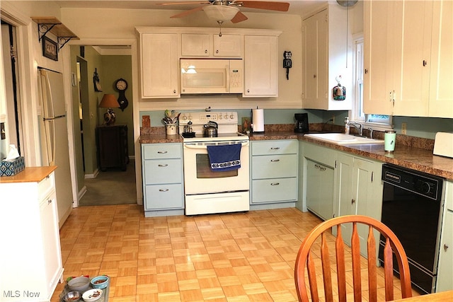 kitchen with white cabinetry, sink, light parquet flooring, and white appliances