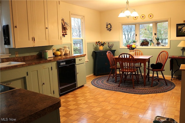 dining room featuring a wealth of natural light, a notable chandelier, and sink