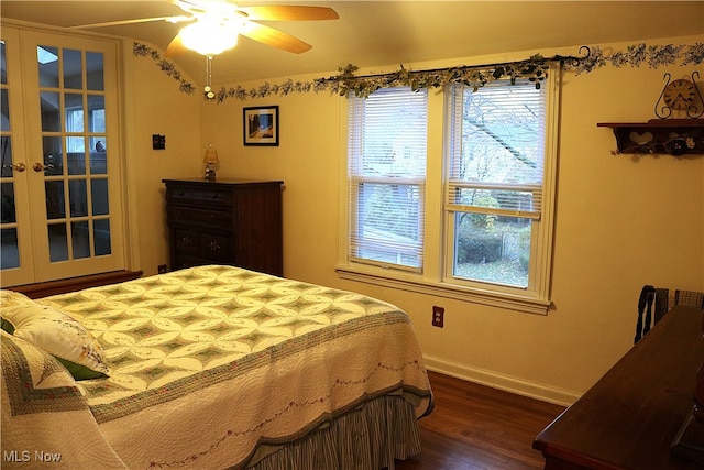 bedroom with ceiling fan, french doors, and dark wood-type flooring