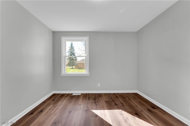 spare room featuring hardwood / wood-style flooring