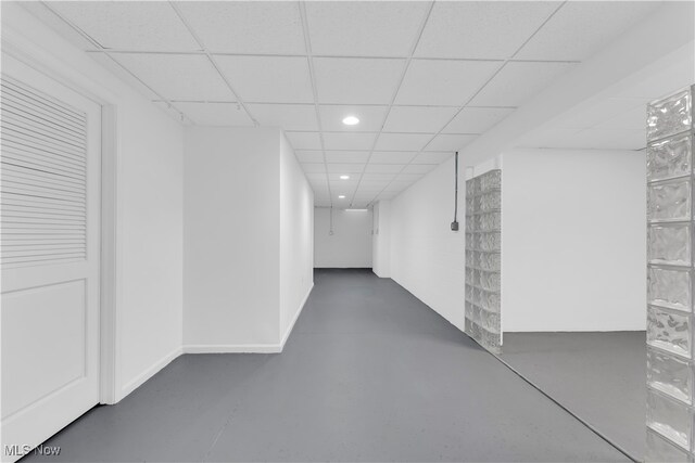 hall featuring a paneled ceiling