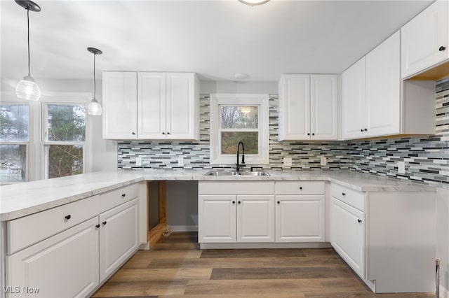 kitchen featuring white cabinets, dark hardwood / wood-style flooring, and plenty of natural light