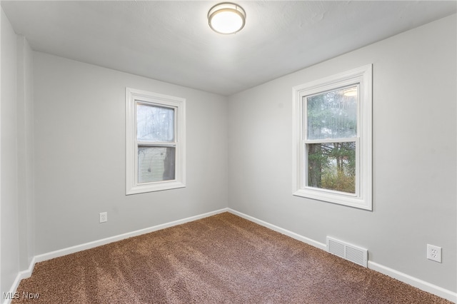 carpeted empty room with plenty of natural light