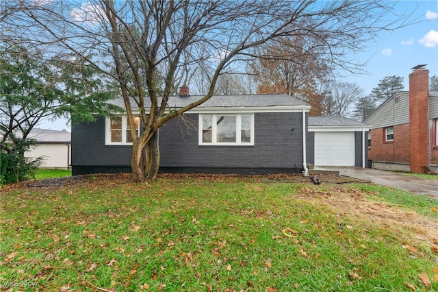 view of front of house with a garage and a front lawn