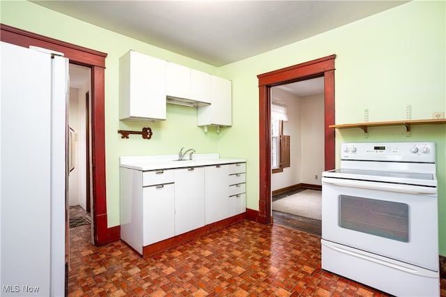 kitchen featuring white cabinets and white appliances