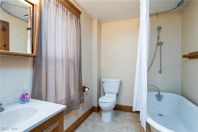 bathroom with vanity, a textured ceiling, and toilet