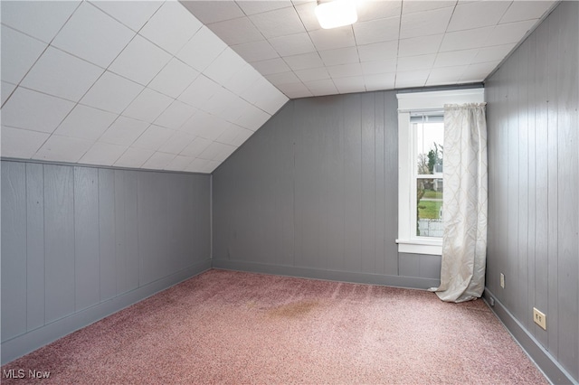 bonus room featuring carpet floors, vaulted ceiling, and plenty of natural light