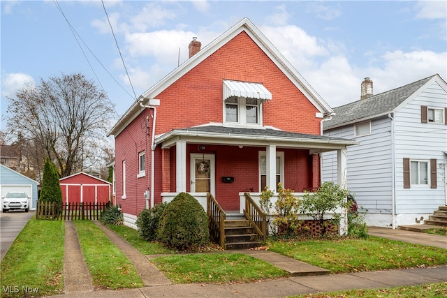 bungalow featuring a front lawn and covered porch