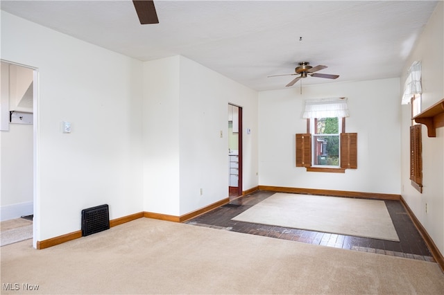 empty room with dark hardwood / wood-style floors and ceiling fan