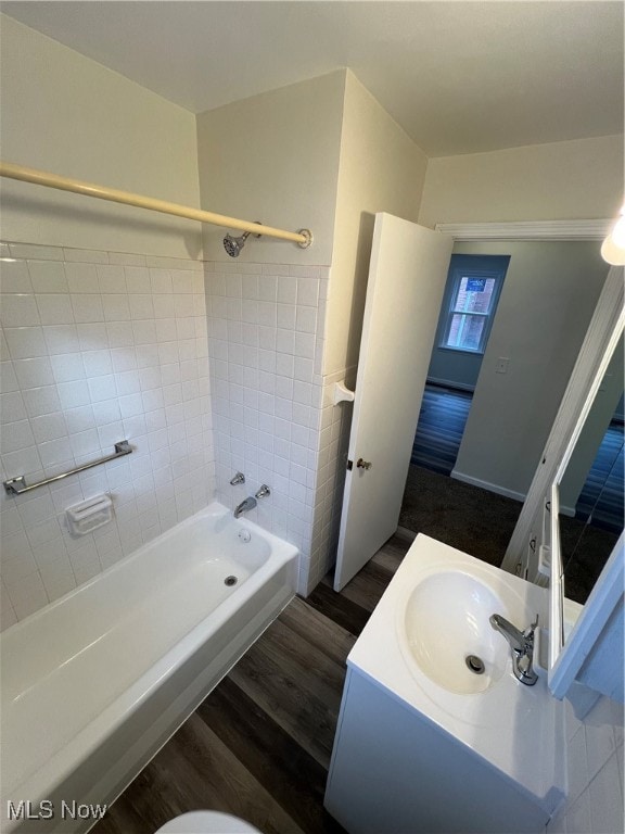 bathroom with vanity, tiled shower / bath, and hardwood / wood-style flooring