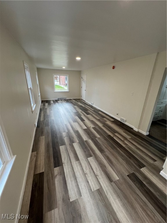 unfurnished living room featuring dark hardwood / wood-style floors