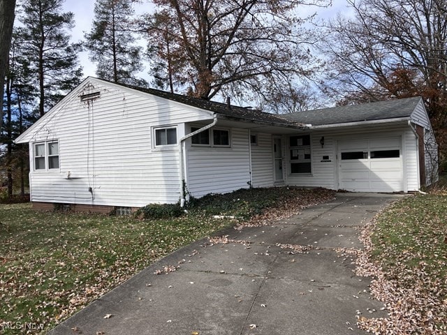 single story home with a front yard and a garage