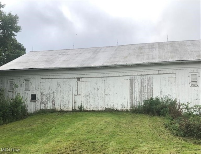 view of outdoor structure with a lawn