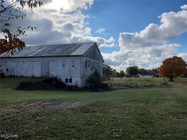 view of outbuilding featuring a lawn