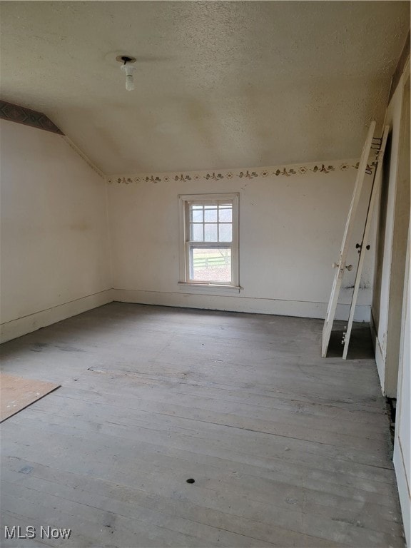 empty room with vaulted ceiling