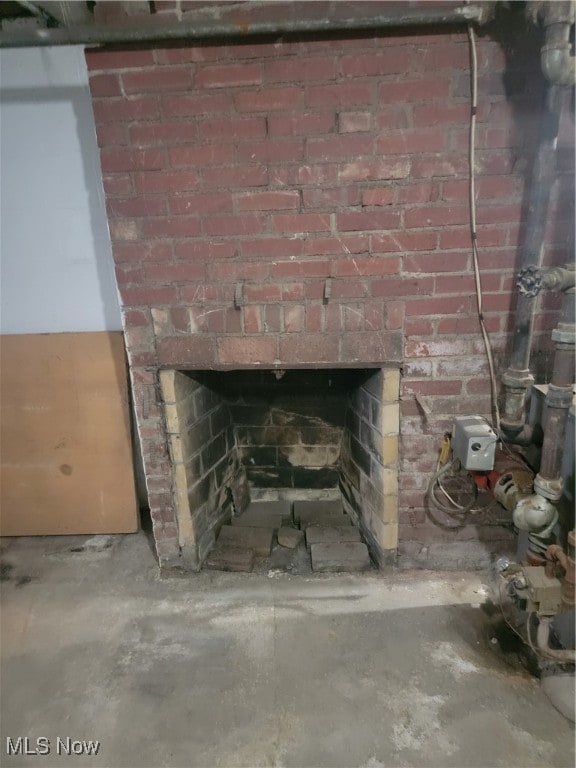 interior details featuring concrete flooring and a fireplace