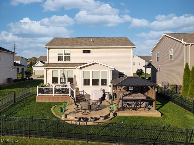 back of property with a gazebo, a patio area, and a yard