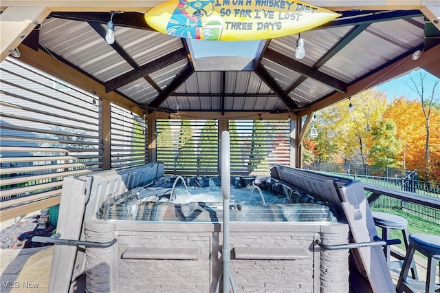 deck with a gazebo and a hot tub