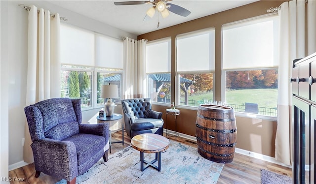 living area with light hardwood / wood-style flooring and ceiling fan