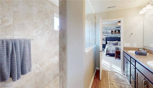 bathroom featuring hardwood / wood-style flooring, ceiling fan, and vanity