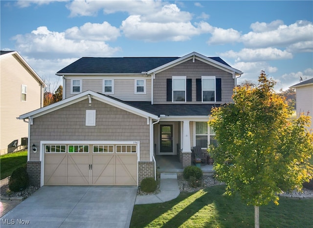 craftsman-style house featuring covered porch and a front yard