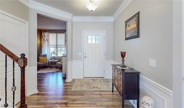 entryway with ornamental molding and dark wood-type flooring