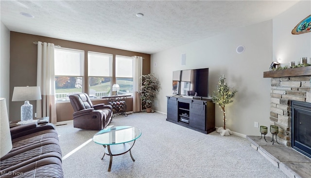 carpeted living room with a fireplace and a textured ceiling