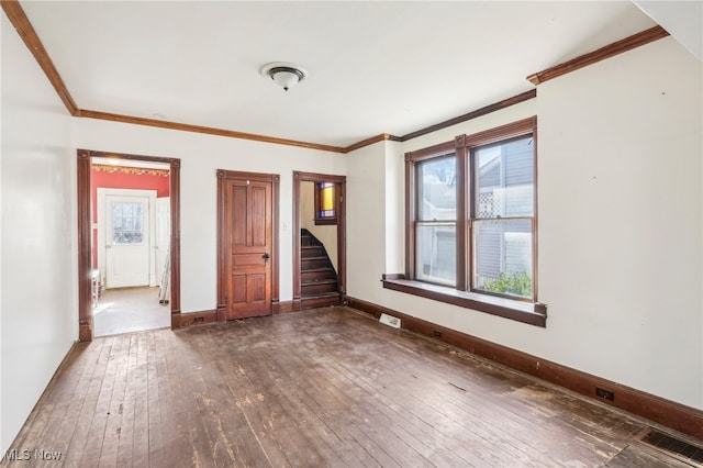 spare room with dark hardwood / wood-style flooring and ornamental molding