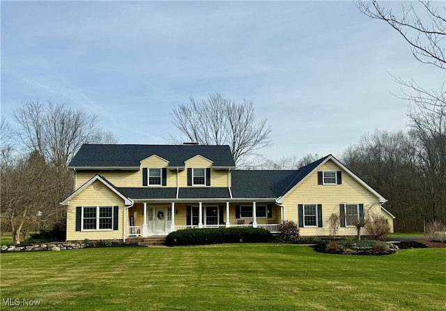 cape cod house with a porch and a front lawn