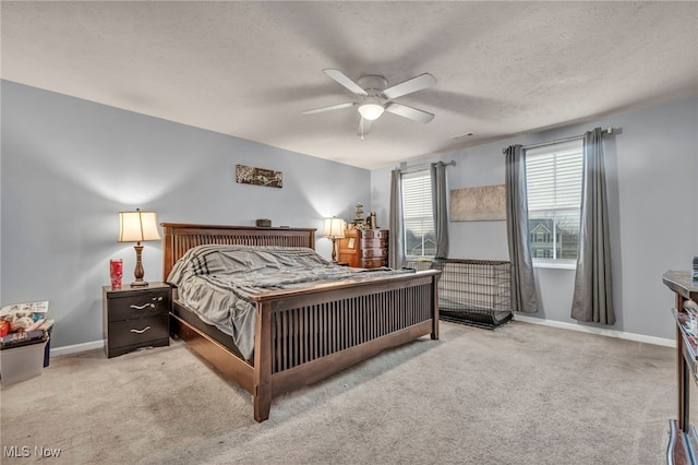 carpeted bedroom featuring a textured ceiling and ceiling fan