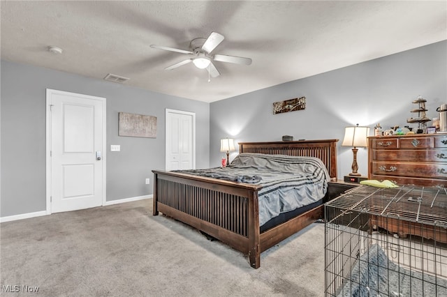 bedroom with light carpet, a closet, ceiling fan, and a textured ceiling