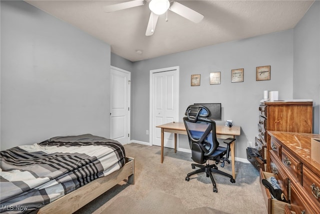 carpeted bedroom featuring a textured ceiling, a closet, and ceiling fan