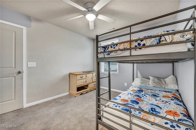 bedroom with carpet flooring, ceiling fan, and a textured ceiling