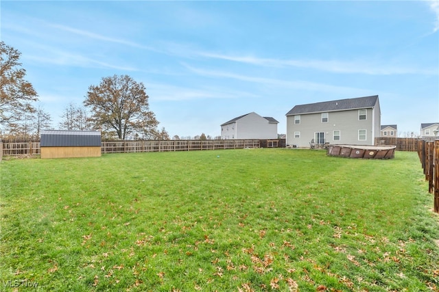 view of yard featuring a storage shed and a swimming pool