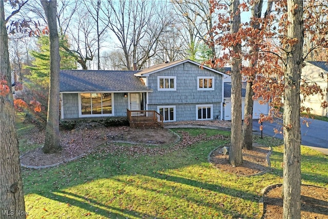 split level home featuring a front lawn